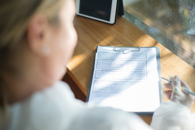 girl filling out competency application form